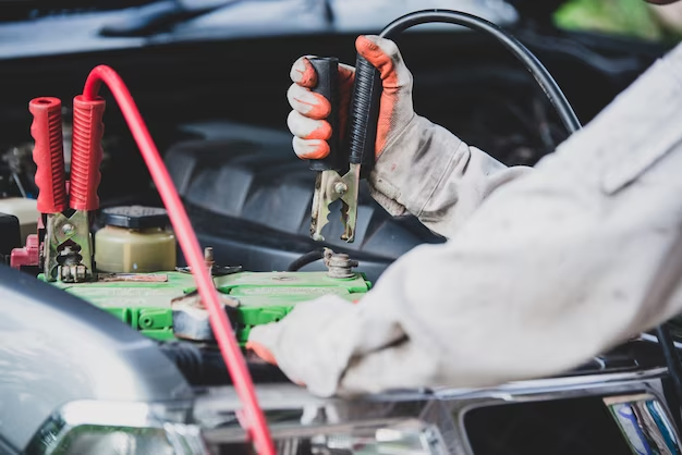 A close-up of a car battery tester displaying the battery's health status