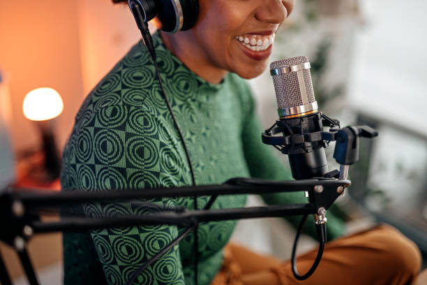 Person speaks into a professional microphone, demonstrating equipment options for streaming.